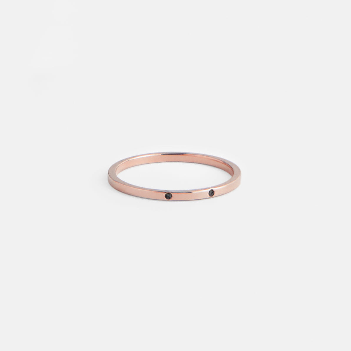 14k rose gold delicate band featuring two black round diamonds