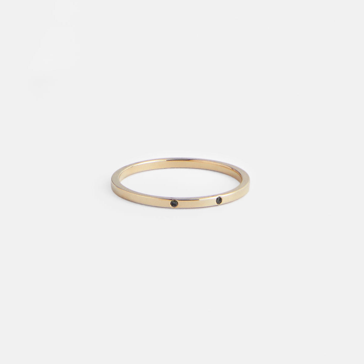 14k yellow gold thin wedding band with two black round diamonds