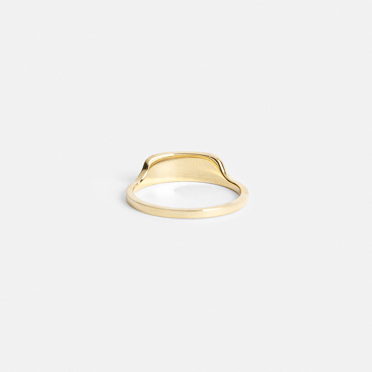 Delicate gold ring highlighting front design from the side