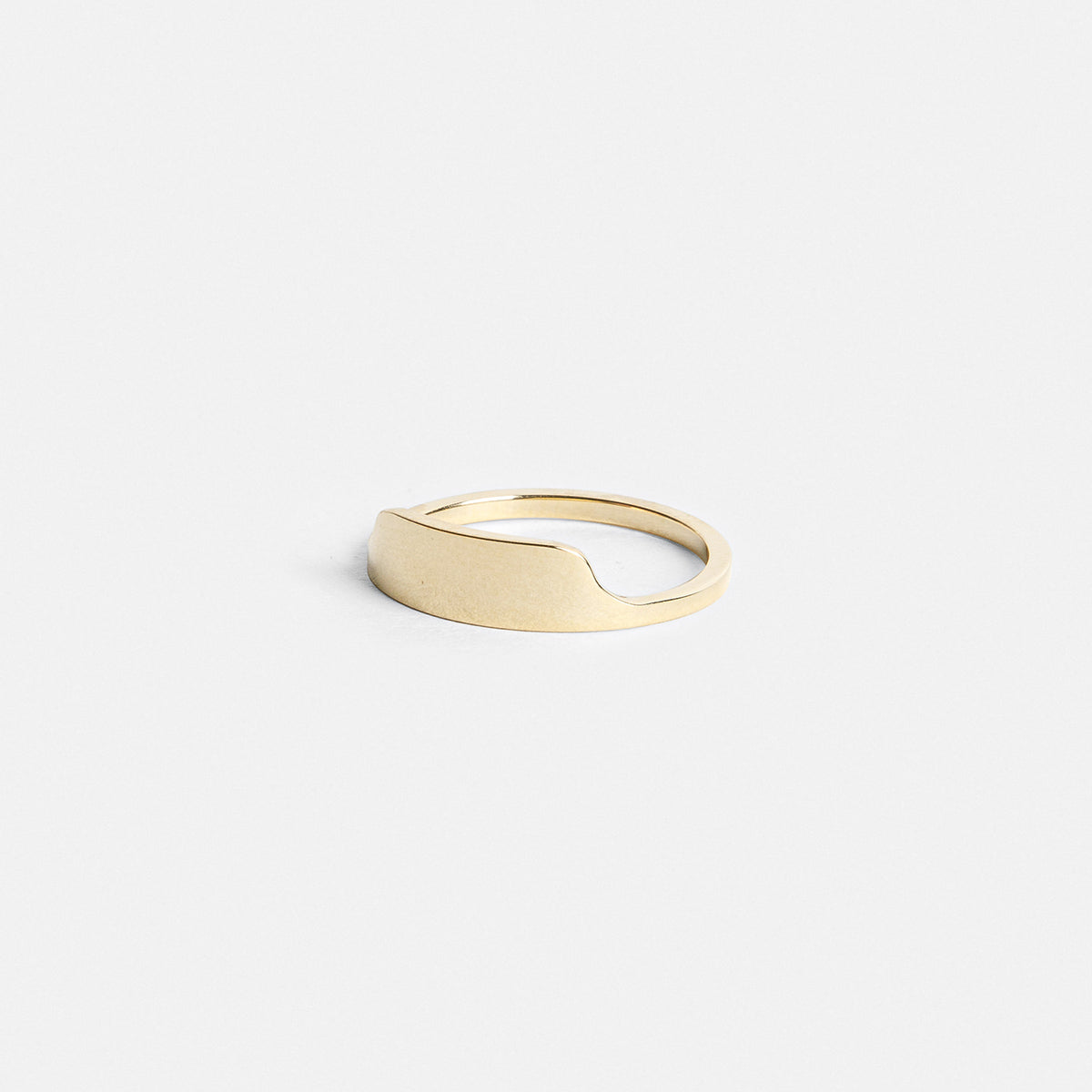 Slim gold ring showing raised front design