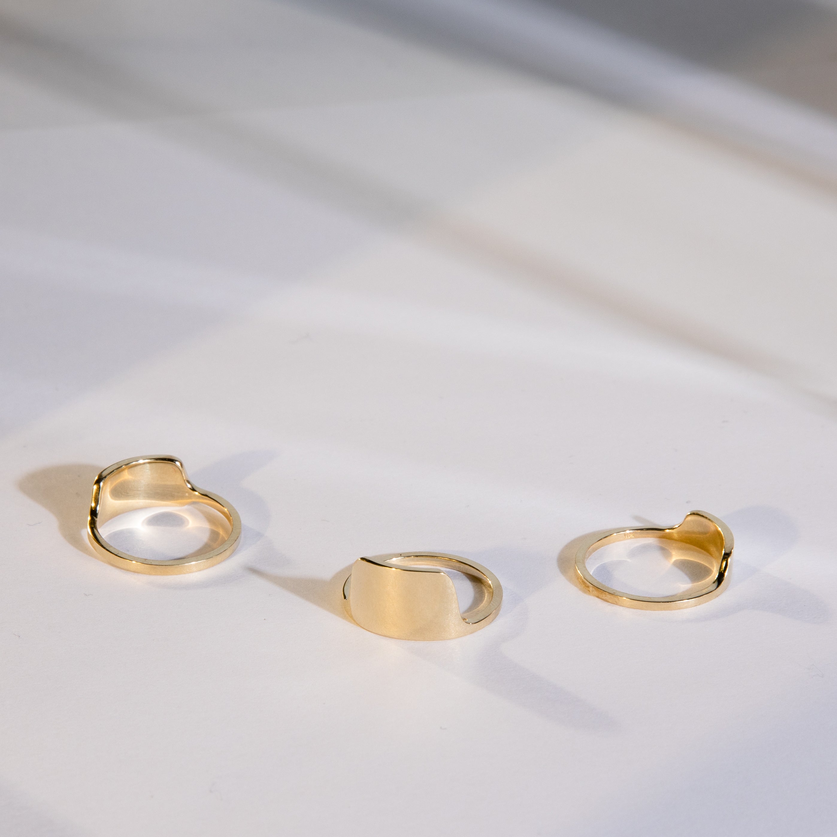 Tylu gold wedding band styled with two other rings from SHW