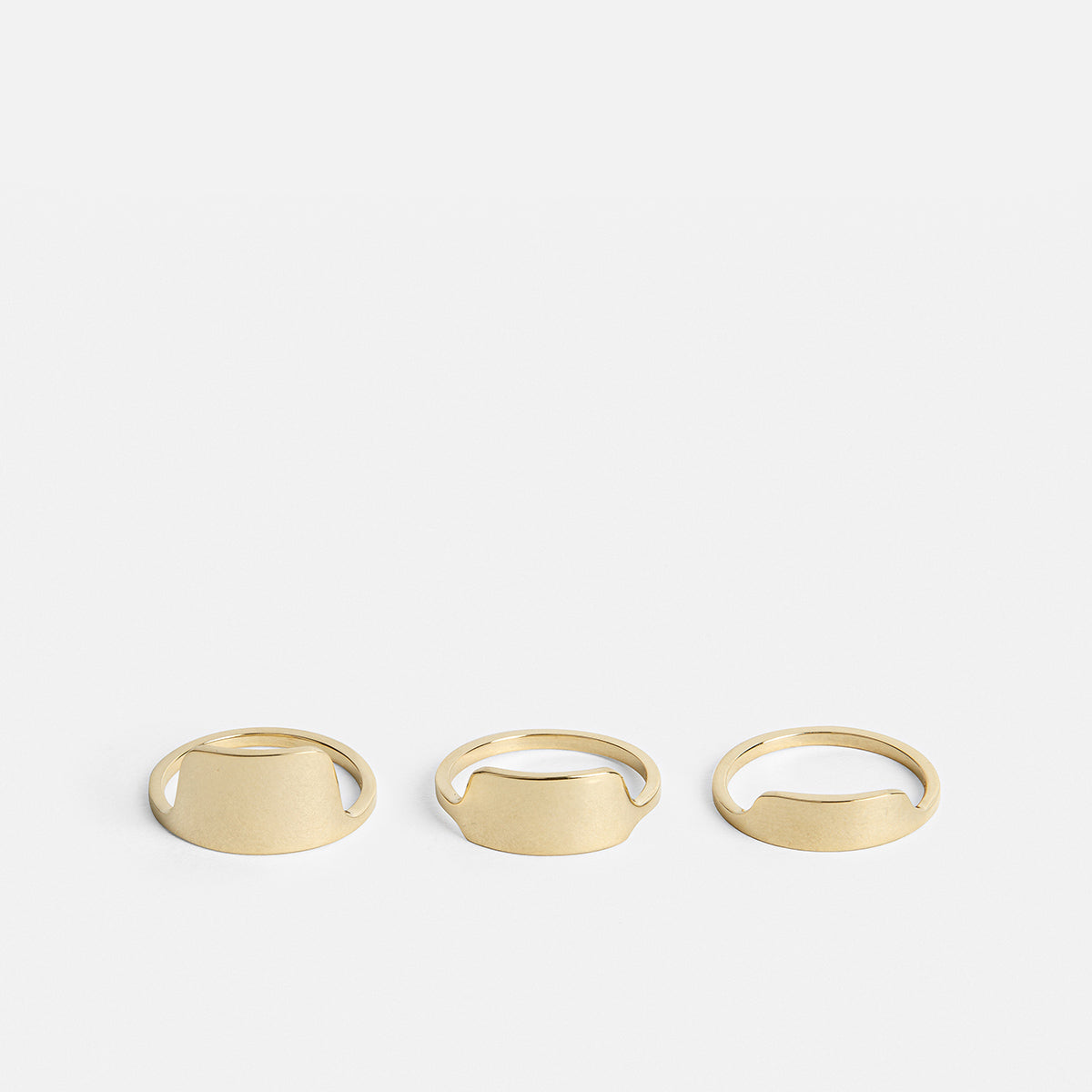 Tylu gold wedding band shown alongside two additional SHW rings