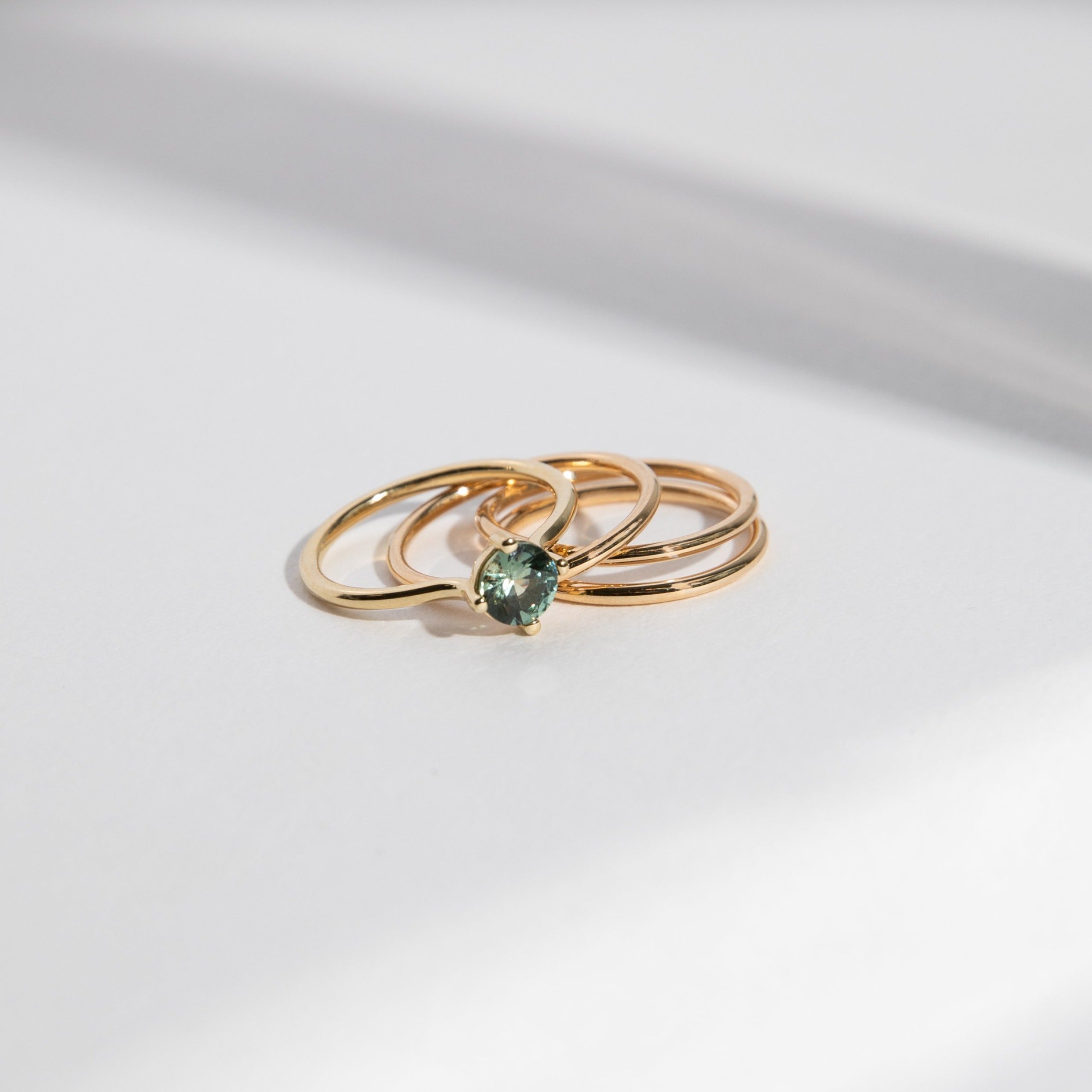 Velu Simple Ring in 14k Gold set with a 0.8ct green round brilliant cut sapphire By SHW Fine Jewelry NYC
