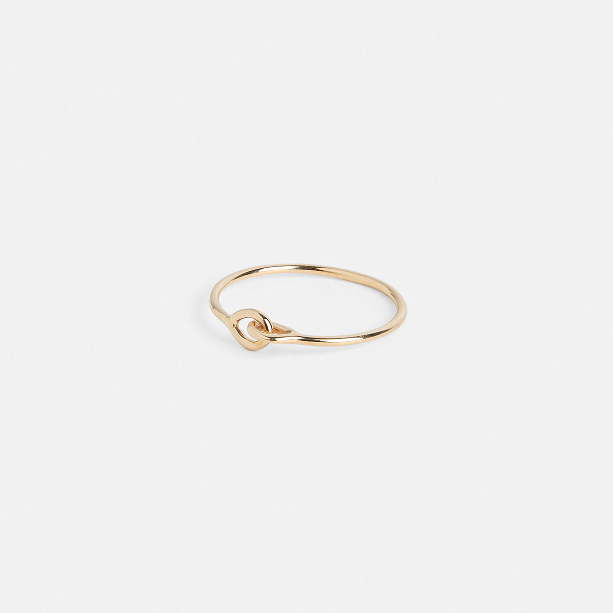 Delicate gold ring showing raised connecting detail from the side